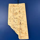 Wooden map of Alberta on a blue wall