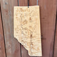 Wooden map of Alberta with engraved details on a wooden background